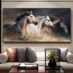 لوحة كنفاس فنية تعرض ثلاثة خيول بألوان رمادية وبيضاء، تجسد حركة وأناقة الخيول في تصميم عصري.