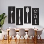 لوحة أكريليك بأربعة أقسام تظهر أدوات المائدة وكلمة "eat" بتصميم عصري باللون الأسود.